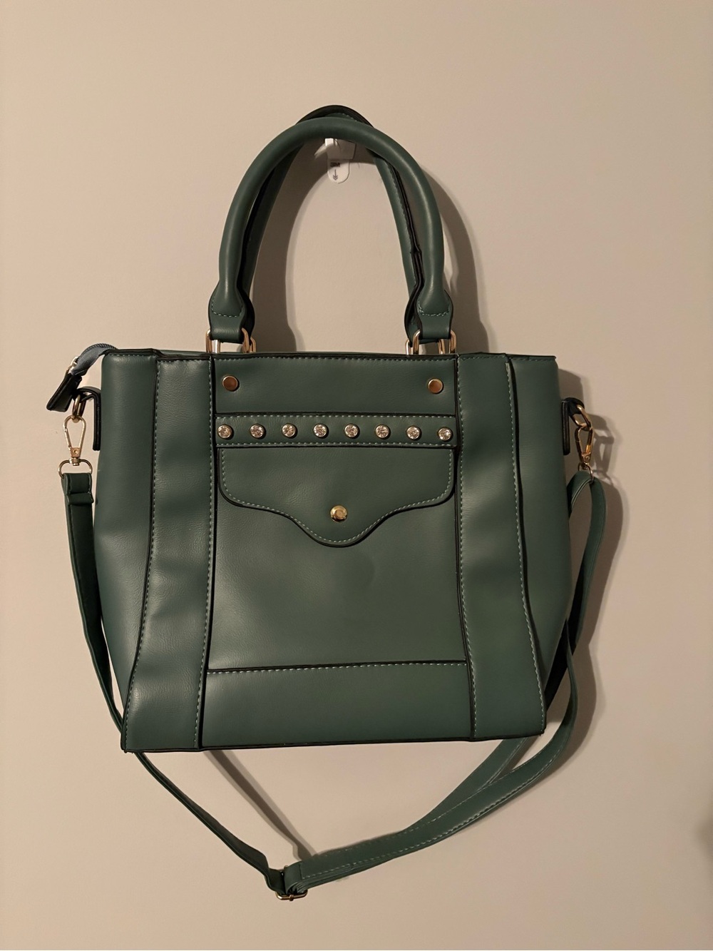 Green women’s studded accent tote bag with adjustable cross body strap